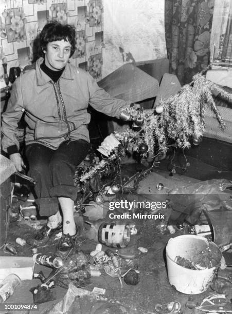 Welsh Floods 1979, picture shows The aftermath of Christmas, Mrs Mary Milton clears up in the damaged front room of her home in Trehafod, 27th...