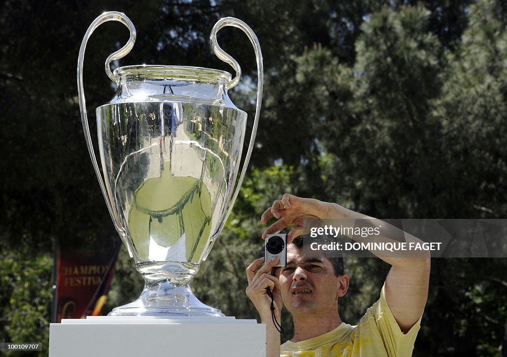 A man takes a picture of the UEFA Champi
