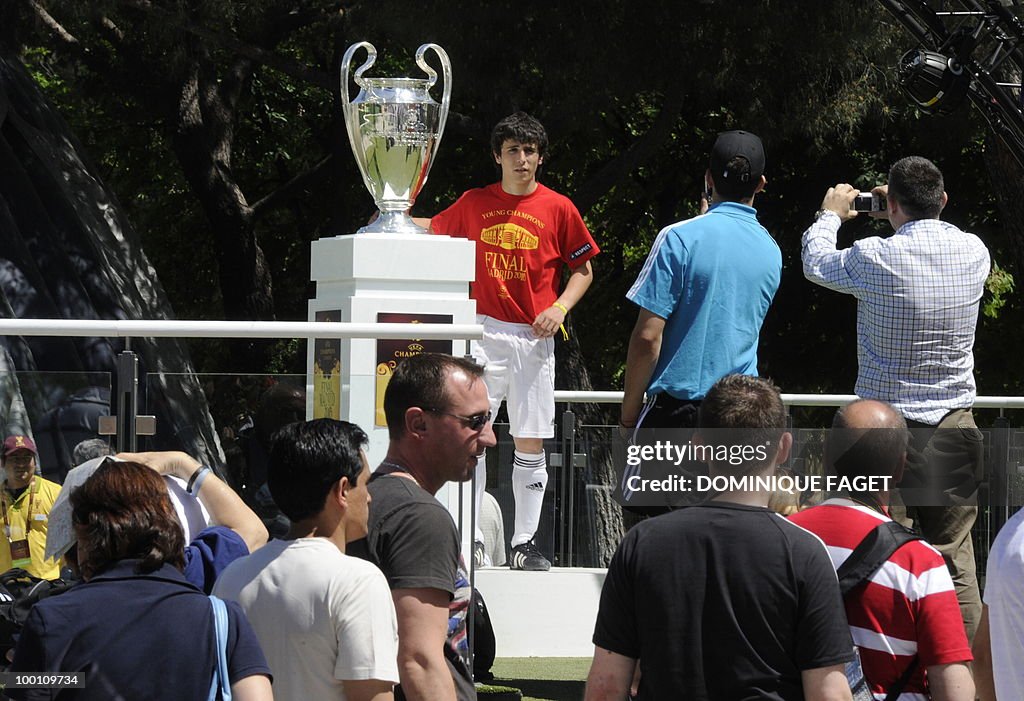 Men take pictures of the UEFA Champions