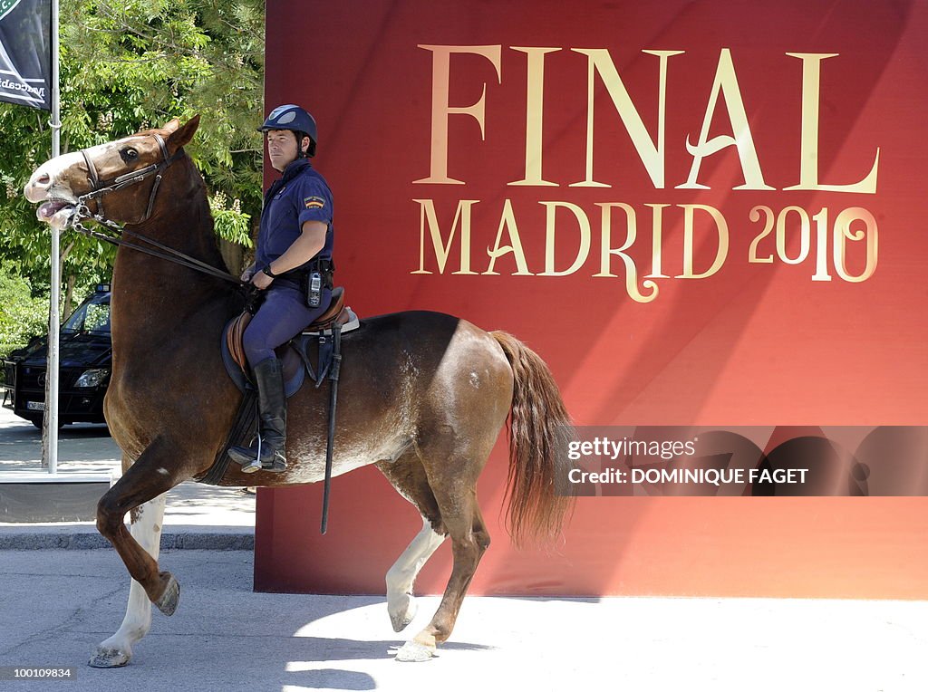 A policeman on horseback passes a banner