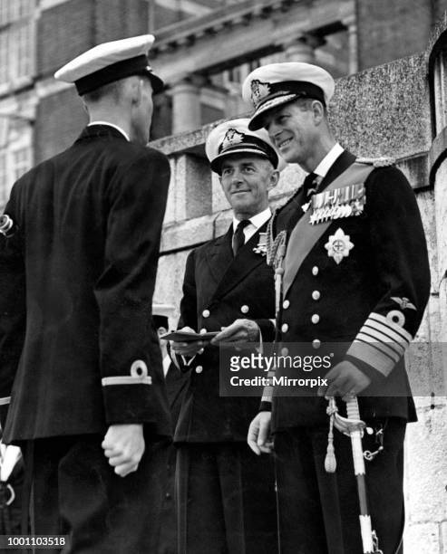 Prince Philip, Duke of Edinburgh presents the Queen's Telescope end of term prize at the passing out parade, Dartmouth College, to Chief Cadet...
