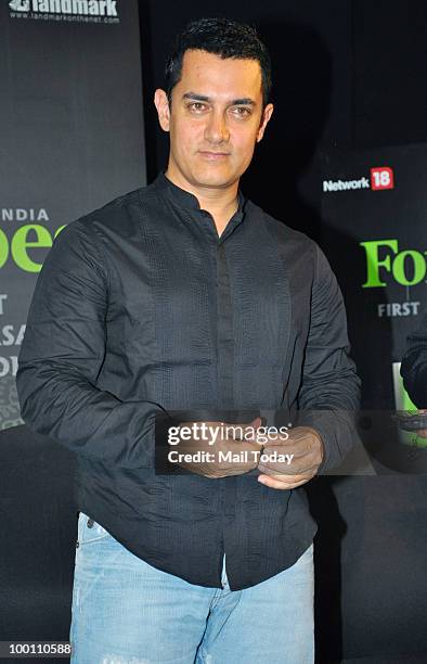 Bollywood actor Aamir Khan unveils a first anniversary edition of Forbes Magazine in Mumbai on May 20, 2010.