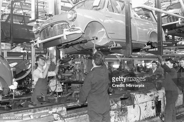 The front axel and engine seen here being mounted on to a Austin Mini on the production line at Longbridge, 10th March 1963 .