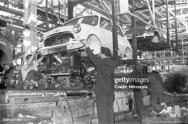 The engine is fitted to a Austin Mini on the production line, Longbridge, 10th March 1963 .