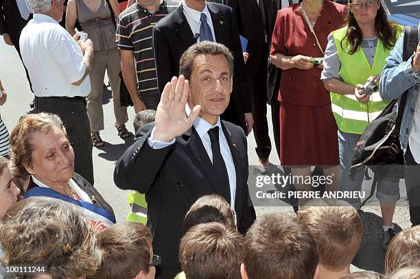 French President Nicolas Sarkozy waves to the crowd after visiting a local farm, on May 21, 2010 in Bouglon, southwestern France, during his visit in...