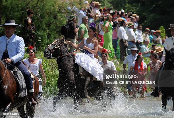 Pilgrims make their way to the shrine of El Rocio crossing the Quema river during the annual El Rocio pilgrimage, on May 21, 2010 in Villamanrique,...