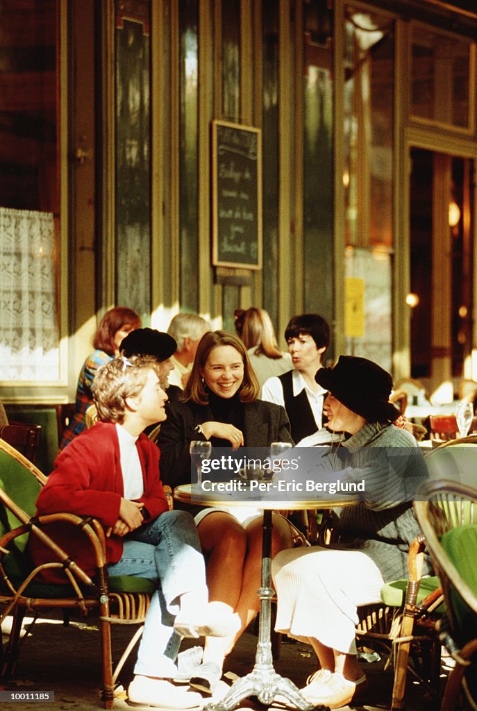 WOMEN ENJOYING DRINKS AT OUTDOOR CAFE