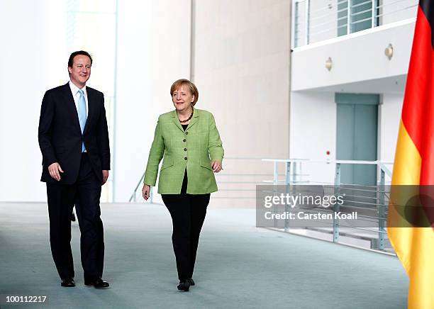British Prime Minister David Cameron and German Chancellor Angela Merkel arrive to a press conference at the Chancellery on May 21, 2010 in Berlin,...