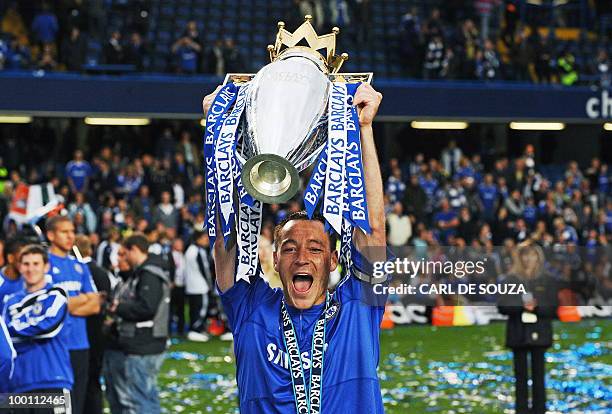Chelsea's captain John Terry celebrates with the Barclays Premier league trophy after they win the title with a 8-0 victory over Wigan Athletic in...