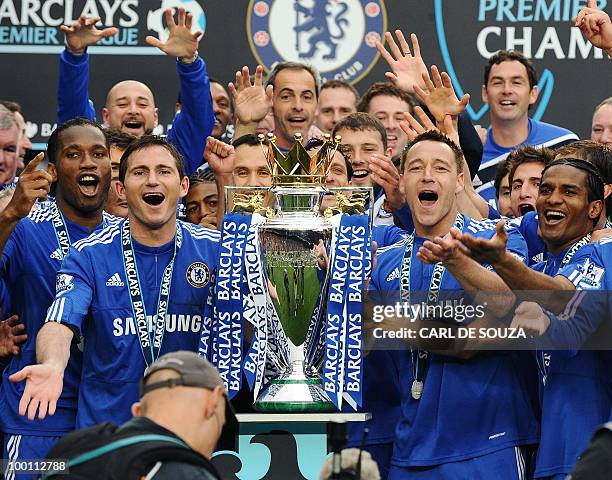 Chelsea players celebrate with the Barclays Premier League trophy after Chelsea win the title with a 8-0 victory over Wigan Athletic in the English...