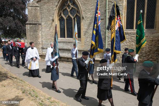 The coffin of World War 2 veteran Patrick Churchill is carried into St Mary The Virgin Church in Witney on July 18, 2018 in Oxfordshire, England....
