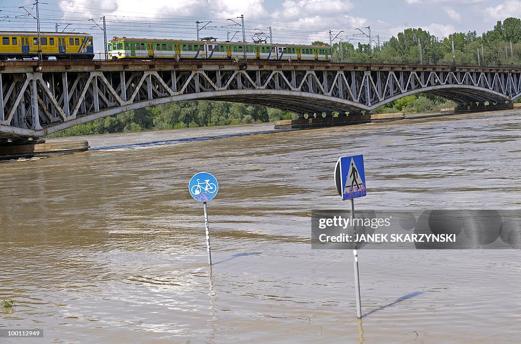 Trains pass on a bridge above flooded wa