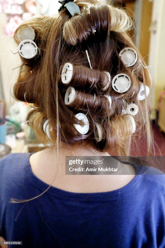 Rear view of young girl's hair fixed with hair rollers