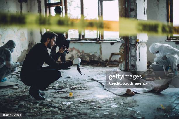 collecting evidence on a crime scene - murder victim stock pictures, royalty-free photos & images