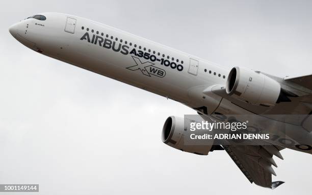 An Airbus A350-1000 XWB passenger aircraft, with Rolls Royce engines, performs in a flying display at the Farnborough Airshow, south west of London,...