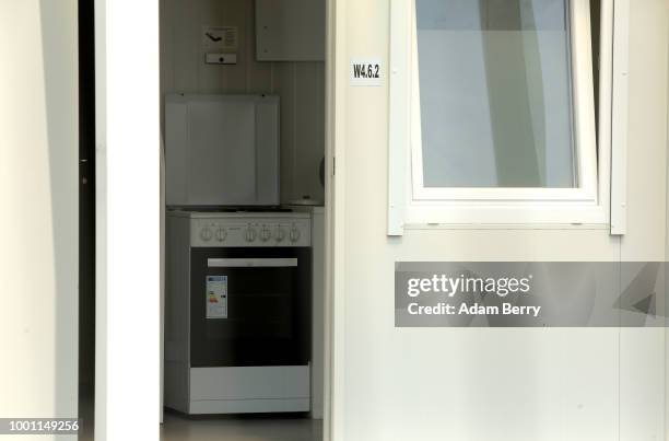 Stove is seen inside a home made from a shipping container inside a temporary asylum seeker reception center at the former Tempelhof airport on July...