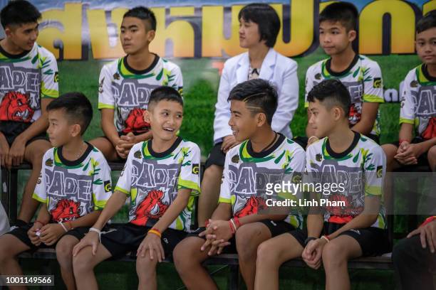Twelve boys and their coach, Ekkapol Chantawong, from the 'Wild Boars' soccer team speak during a press conference for the first time since they were...