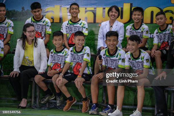 Twelve boys and their coach, Ekkapol Chantawong, from the 'Wild Boars' soccer team speak during a press conference for the first time since they were...