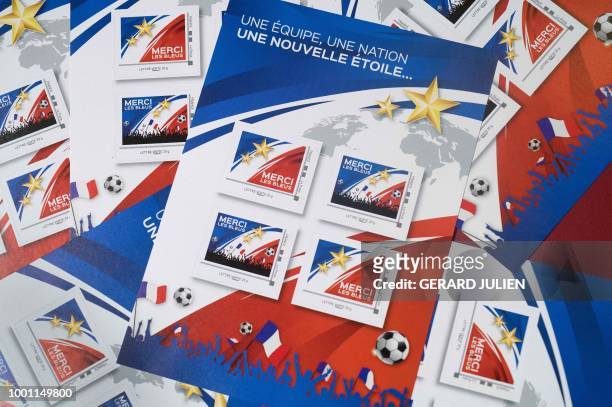This picture taken on July 18, 2018 shows four collector's stamps " Thank you les Bleus " to mark their title of champion of the 2018 FIFA World Cup.