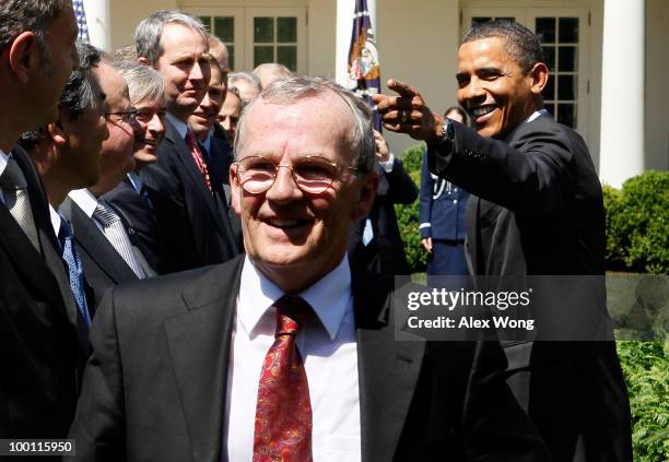 President Barack Obama gestures to the media as he shakes hands with auto industry representatives as President of BMW North America Jim O'Donnell...