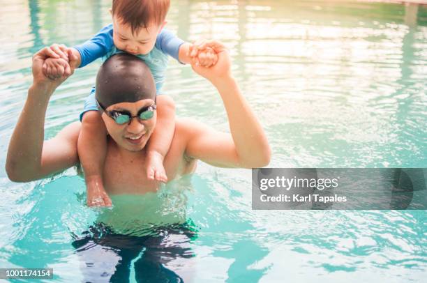 father and son in the swimming pool during sunrise - philippines family 個照片及圖片檔