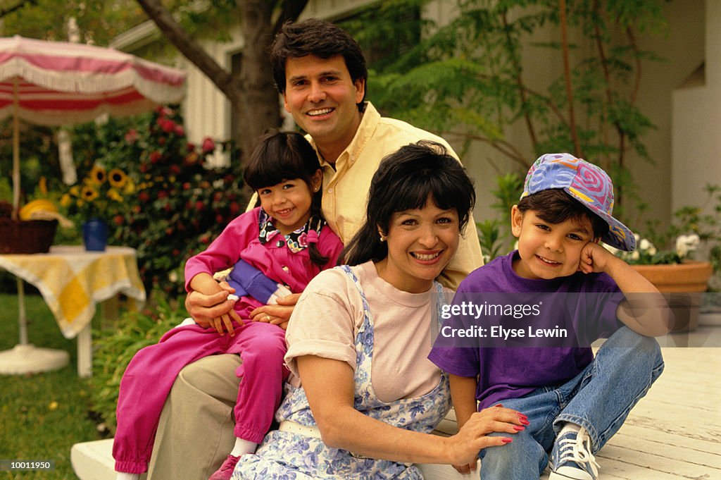 PORTRAIT OF A HISPANIC FAMILY ON BACK PORCH