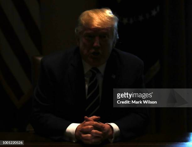The lights temporarily go out in the Cabinet Room as U.S. President Donald Trump talks about his meeting with Russian President Vladimir Putin,...