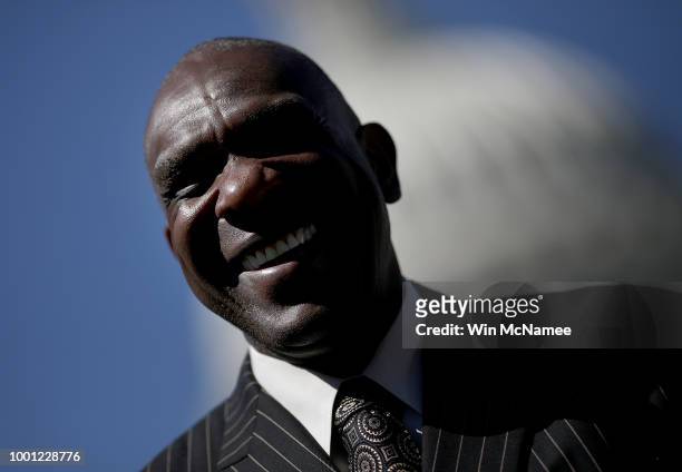 Baseball Hall of Famer Andre Dawson listens as Sen. Tim Scott speaks during a press conference outside the U.S. Capitol July 18, 2018 in Washington,...