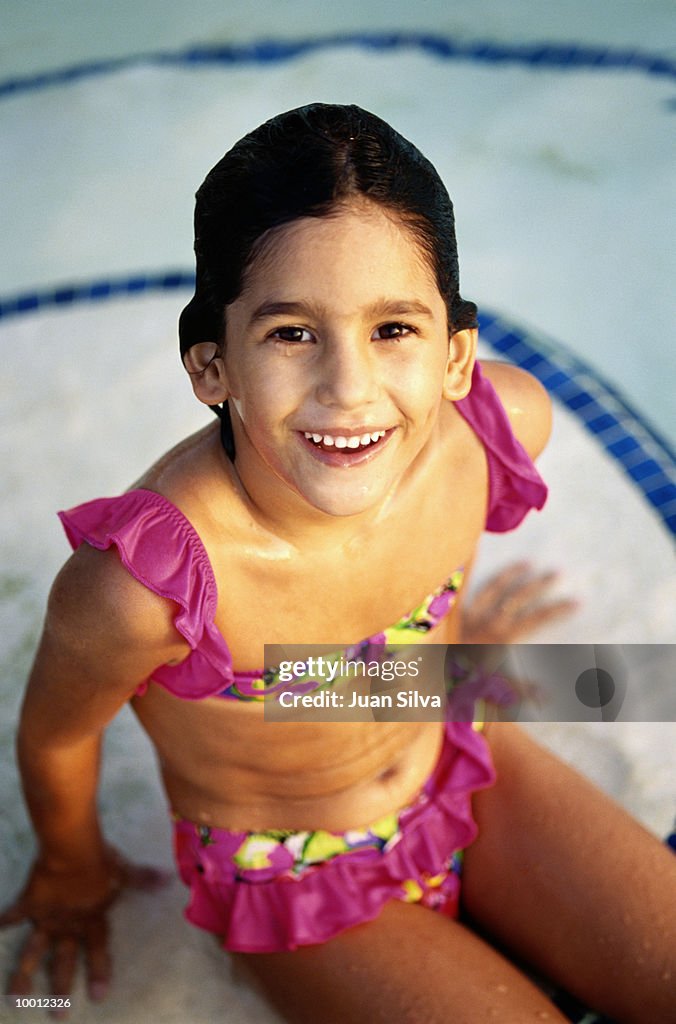 YOUNG GIRL IN SWIMMING POOL