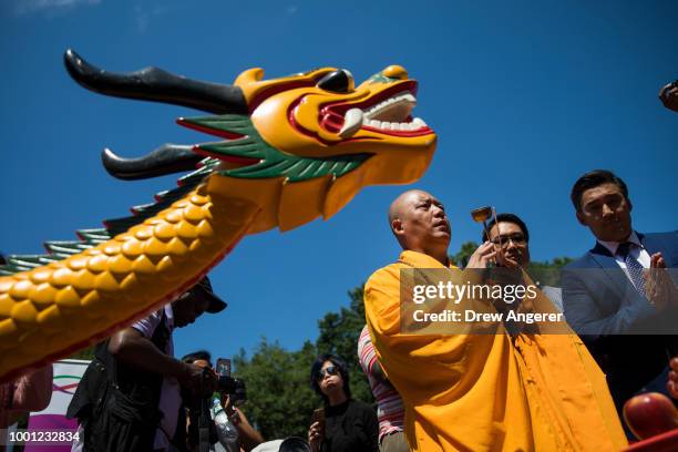 Buddhist monk prepares to bless a dragon boat during a traditional dragon boat awakening ceremony in Central Park, July 18, 2018 in New York City....