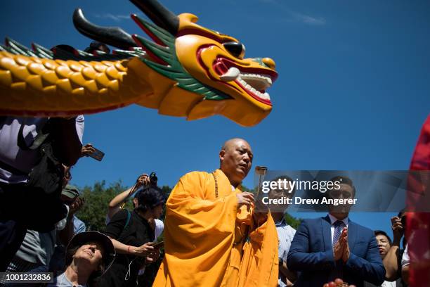 Buddhist monk prepares to bless a dragon boat during a traditional dragon boat awakening ceremony in Central Park, July 18, 2018 in New York City....