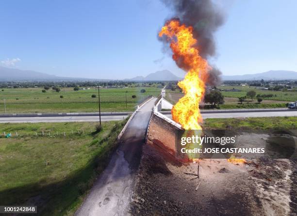 Aerial view taken by a drone showing a fire at a clandestine fuel valve in San Jeronimo Ocotitlan, Acajete, Puebla state, Mexico on July 18, 2018. -...