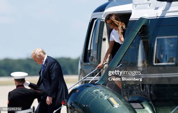 President Donald Trump, second left, and First Lady Melania Trump, right, disembark Marine One while arriving at Joint Airforce Base Andrews,...