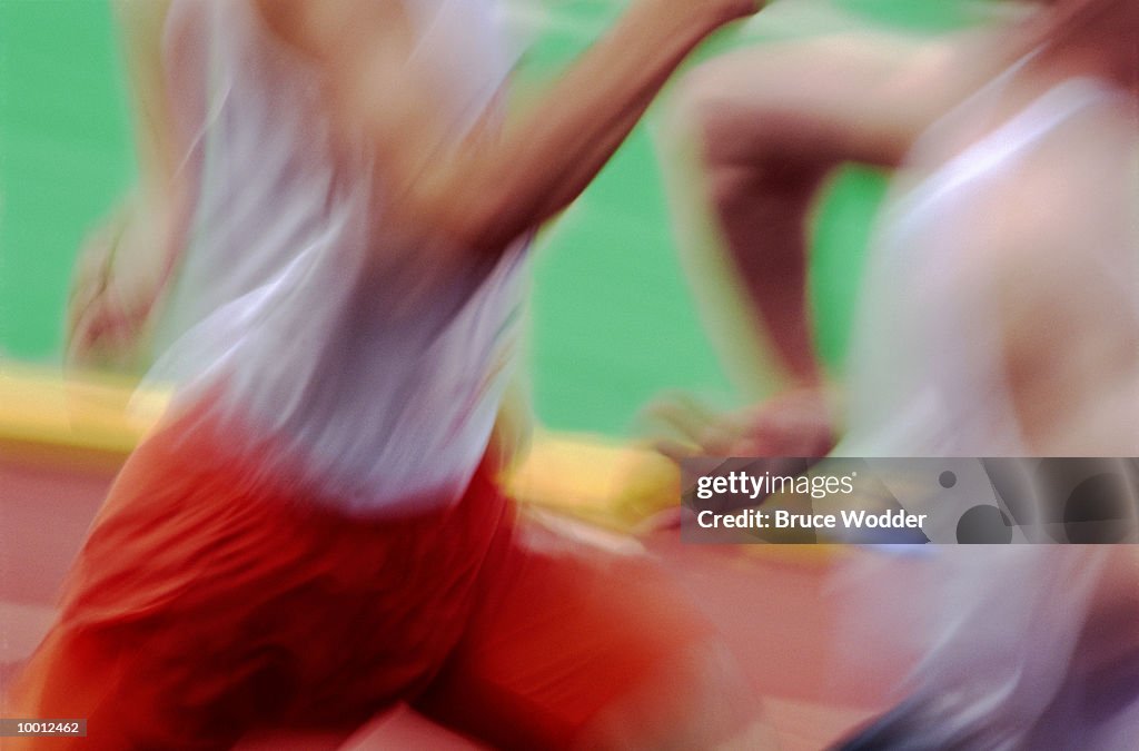 CLOSE-UP OF TRACK RUNNERS IN BLUR