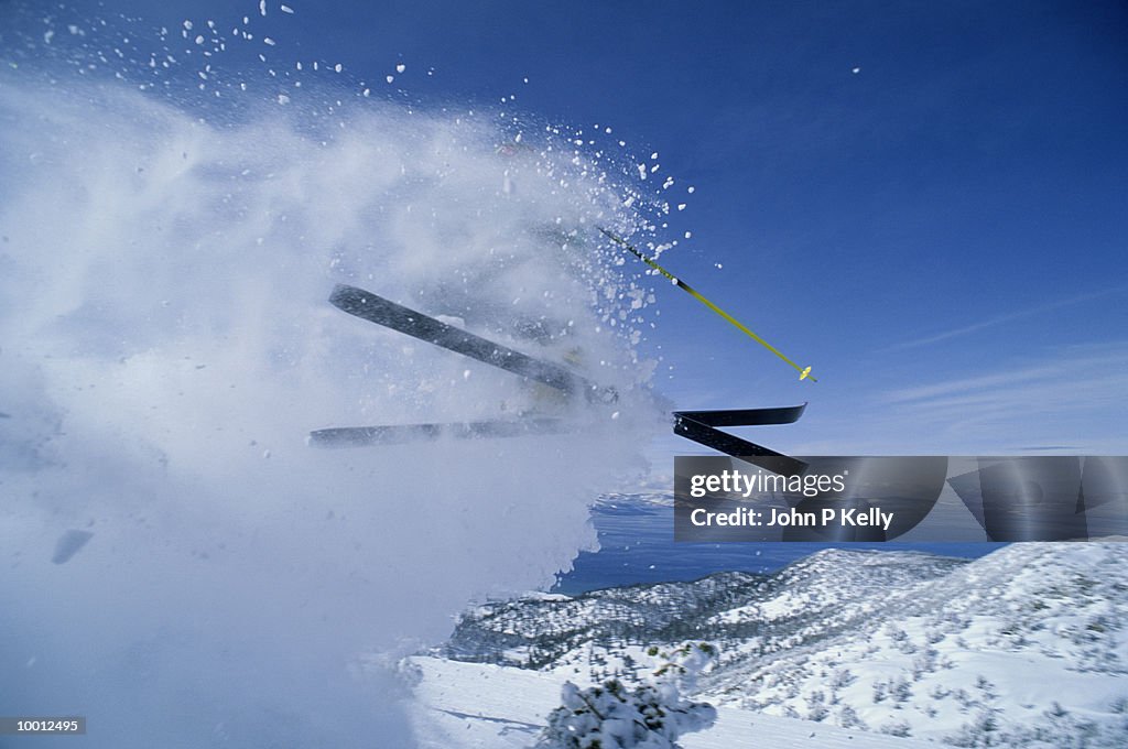 SKIER KICKING UP SNOW IN MIDAIR