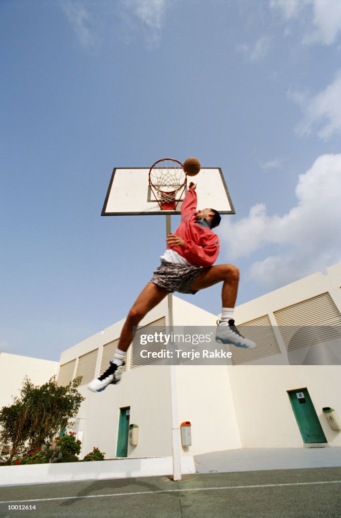 MAN IN MIDAIR PLAYING BASKETBALL