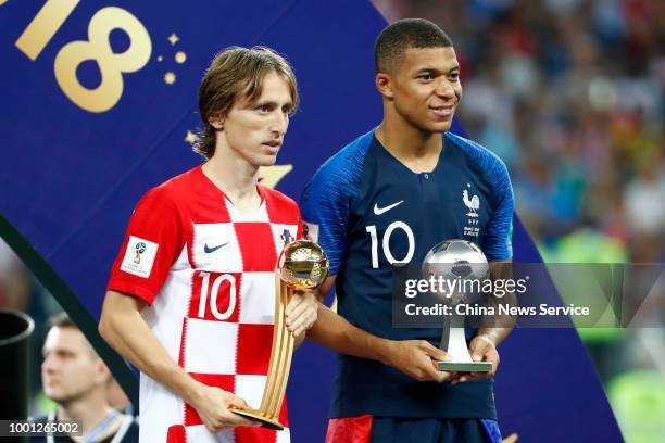 Luka Modric of Croatia wins the Golden Ball award and Kylian Mbappe of France wins the Best Young Player award after the 2018 FIFA World Cup Final...