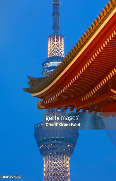 view of television tower and partial view temple. - tokyo sky tree stock-fotos und bilder