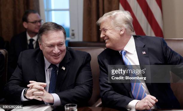 President Donald Trump, right, and Mike Pompeo, U.S. Secretary of state, laugh during a meeting at the White House in Washington, D.C., U.S., on...