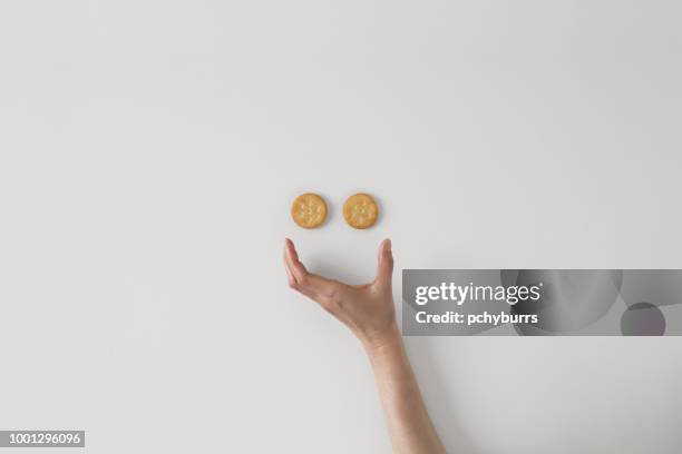 conceptual smiley face - crackers stock-fotos und bilder