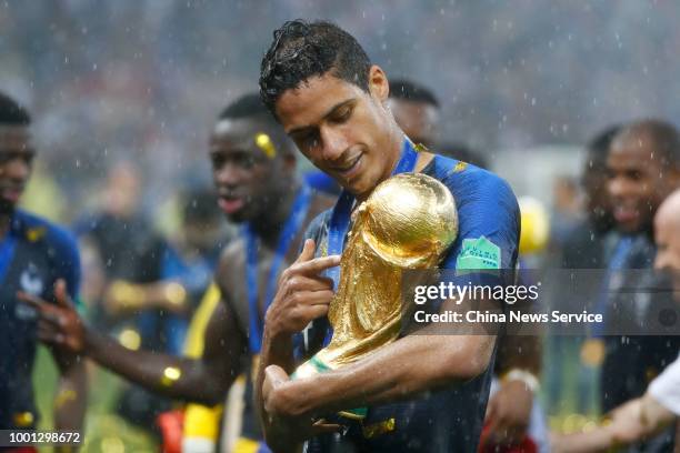 Raphael Varane of France looks at the World Cup trophy after the 2018 FIFA World Cup Final between France and Croatia at Luzhniki Stadium on July 15,...