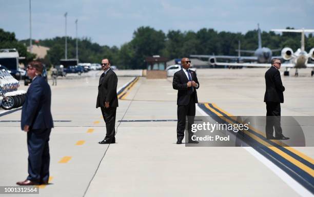 Secret Service agents stand watch as President Donald Trump and first lady Melania Trump arrive to pay their respects to the family of fallen United...