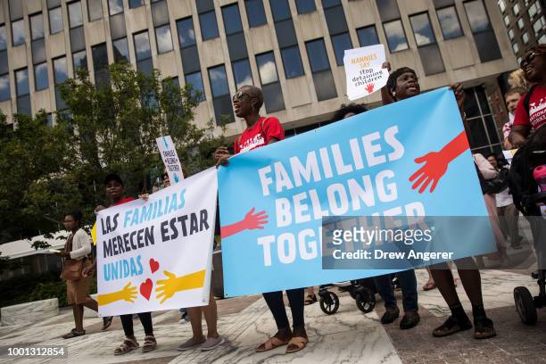 Activists, including childcare providers, parents and their children, protest against the Trump administrations recent family detention and...