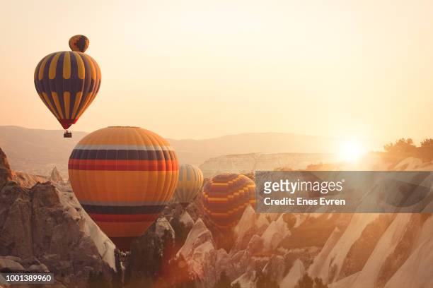 hot air balloon and fairy chimneys in cappadocia - cappadocia hot air balloon stock pictures, royalty-free photos & images