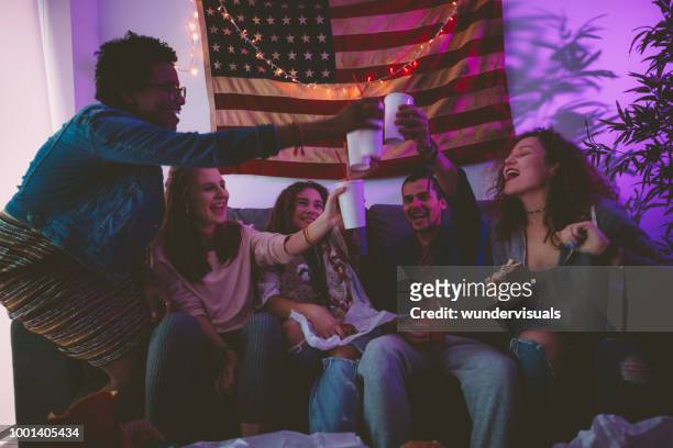 young multi-ethnic friends eating fast food and toasting with soda - college dorm party stock pictures, royalty-free photos & images