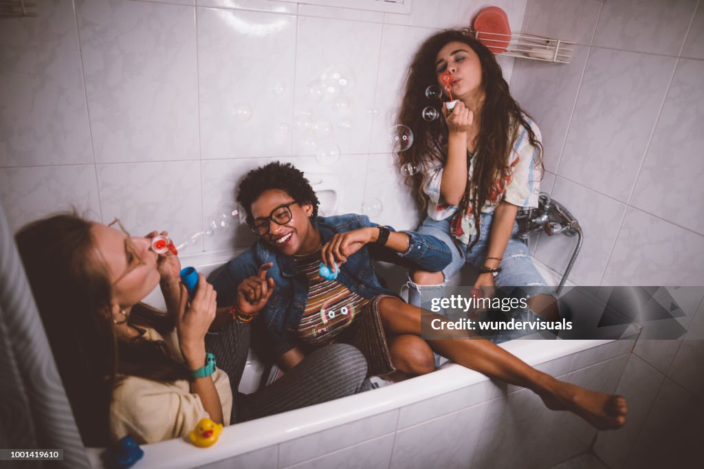 Young teenage girls being silly and having fun blowing bubbles