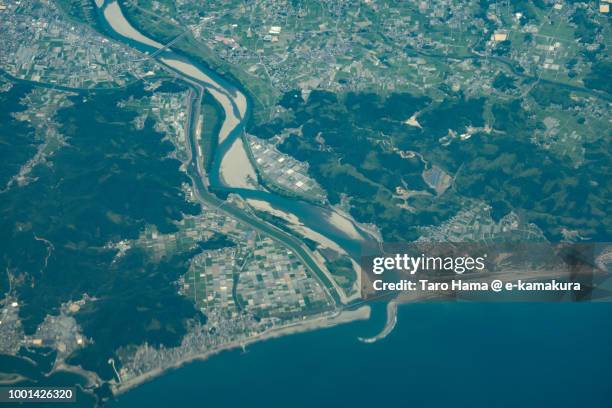 pacific ocean and niyodo river in tosa city in japan daytime aerial view from airplane - tosa city stock pictures, royalty-free photos & images