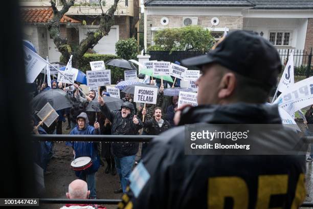 Demonstrators from the news agency Telam hold signs and shout during a protest outside of the Quinta de Olivos presidential residence in Buenos...