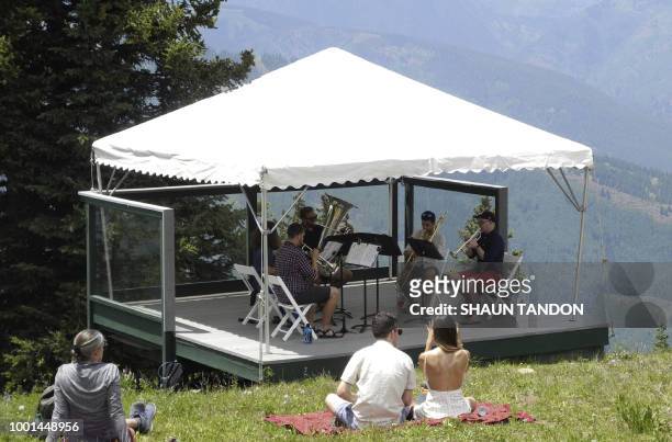 Crowd gathers on top of the Aspen Mountain in Aspen, Colorado, to watch a student brass band perform as part of the Aspen Music Festival on July 7,...