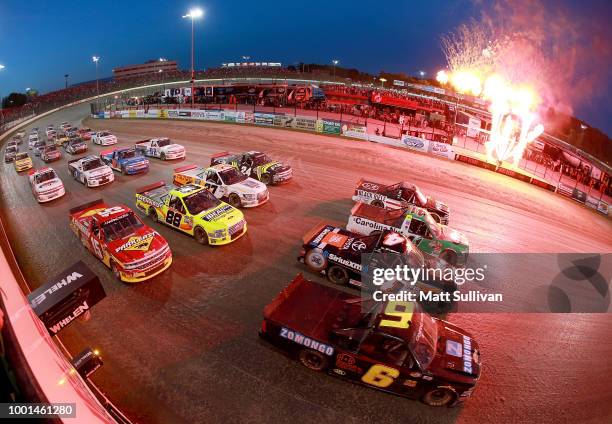 The field does a four-wide military salute prior to the start of the NASCAR Camping World Truck Series Eldora Dirt Derby at Eldora Speedway on July...